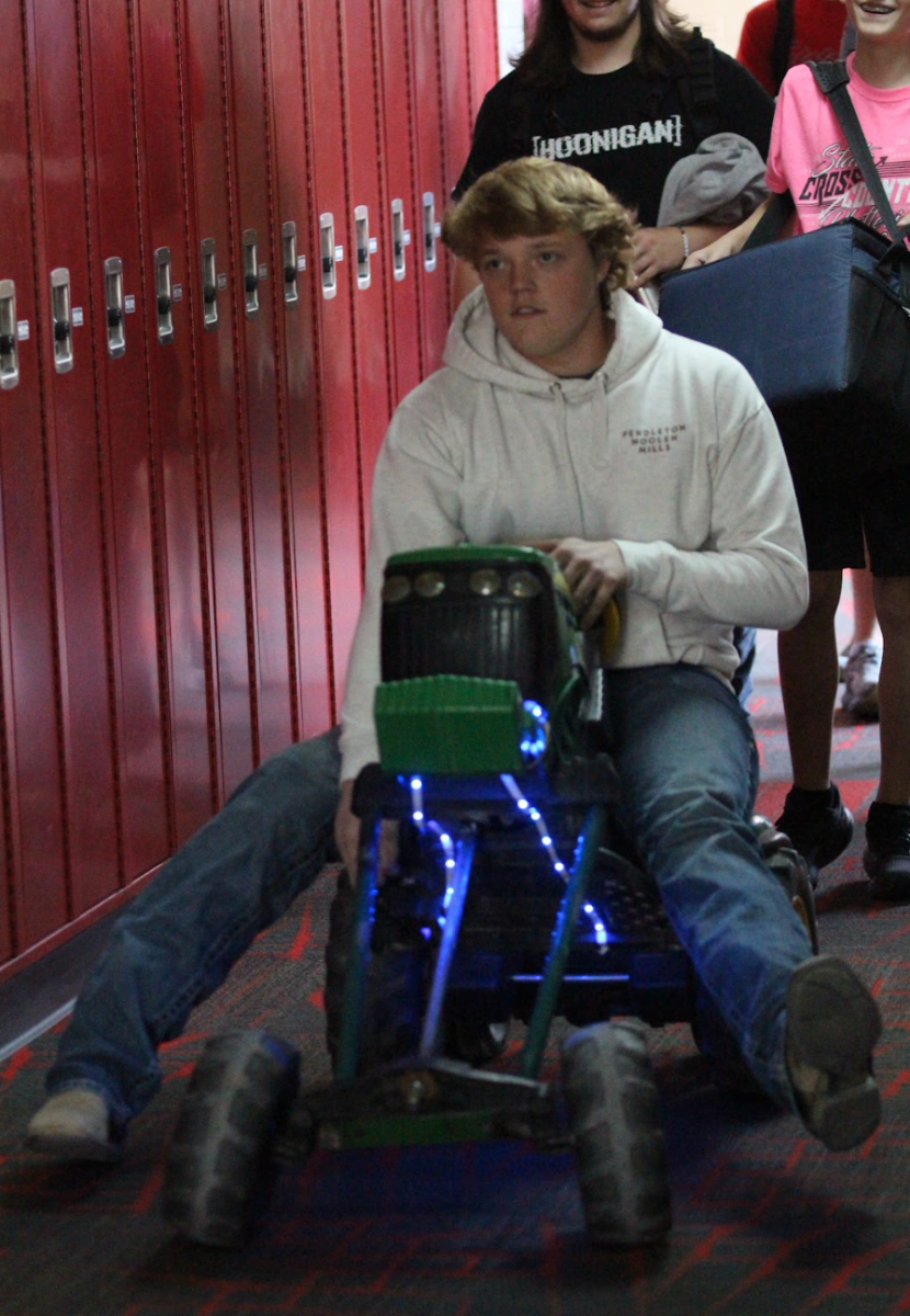 Caden Schram (12) brought a motorized miniature tractor for "Anything But a Backpack" day.